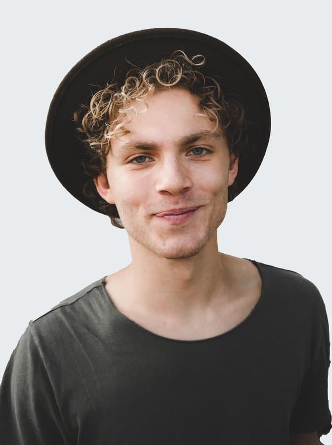A professional smiling in a hat